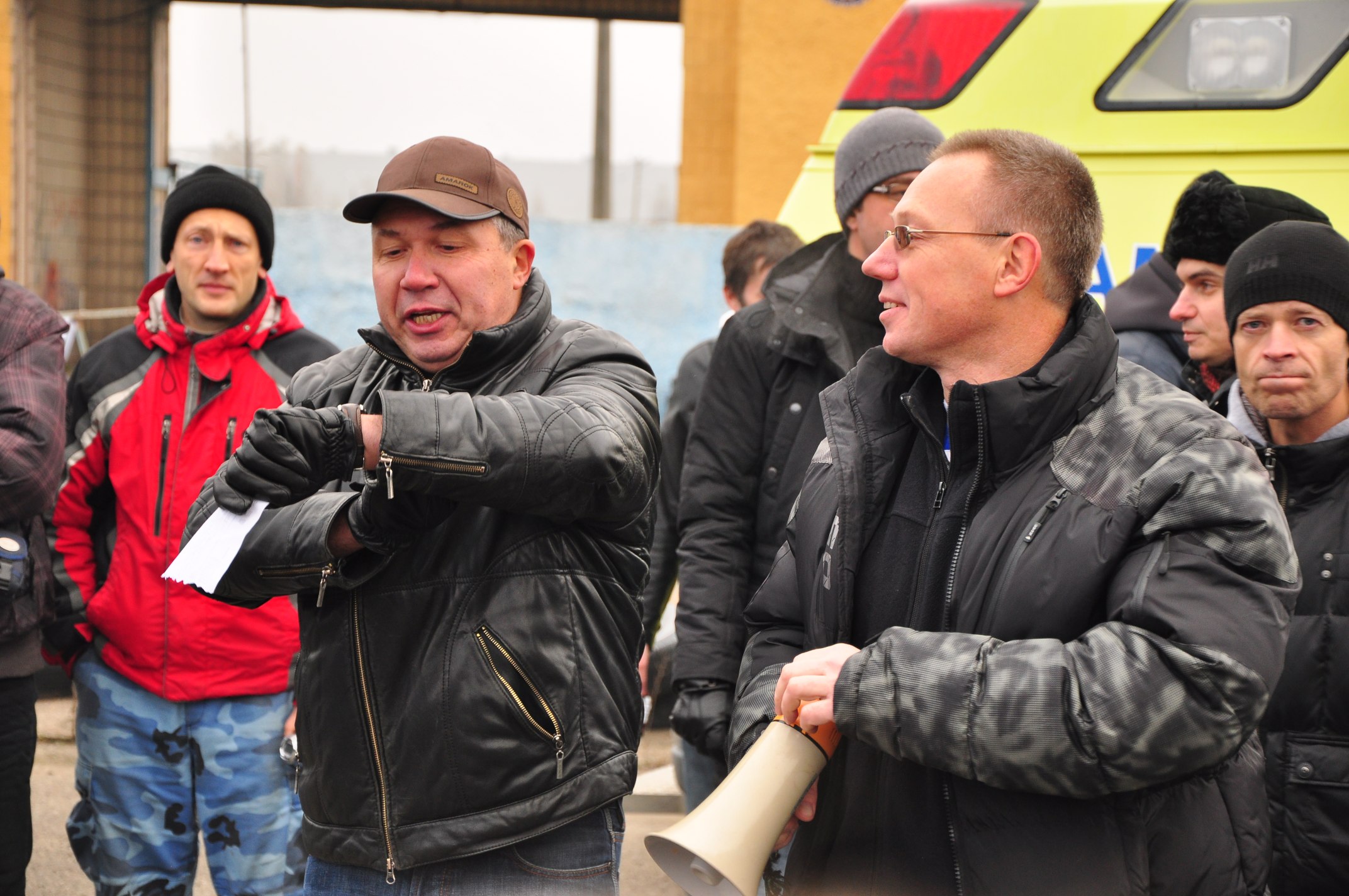 a group of men in winter gear are standing outside