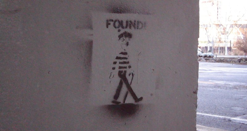 a picture on a pole with a sticker that reads found