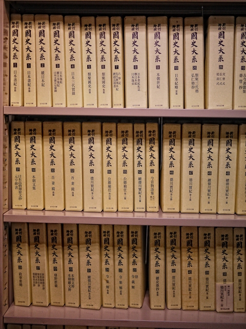 several rows of yellow books on a bookshelf