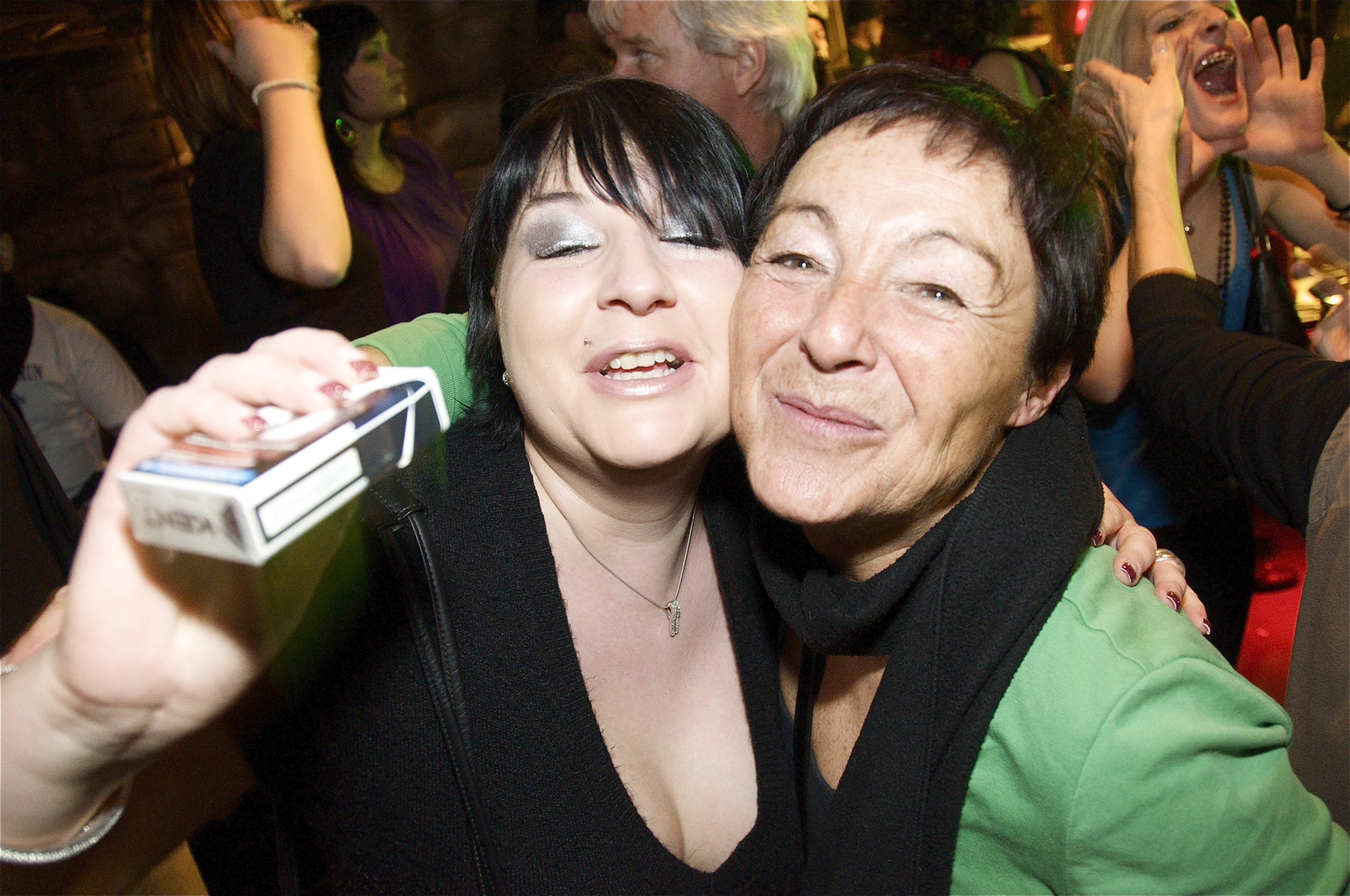 two people taking a picture together at a party