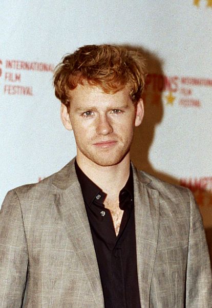 an image of man standing at a red carpet event