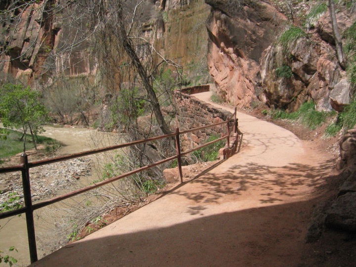 a metal path runs along a cliff face