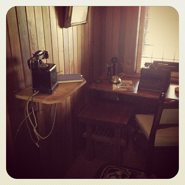 a room with table chairs and a telephone