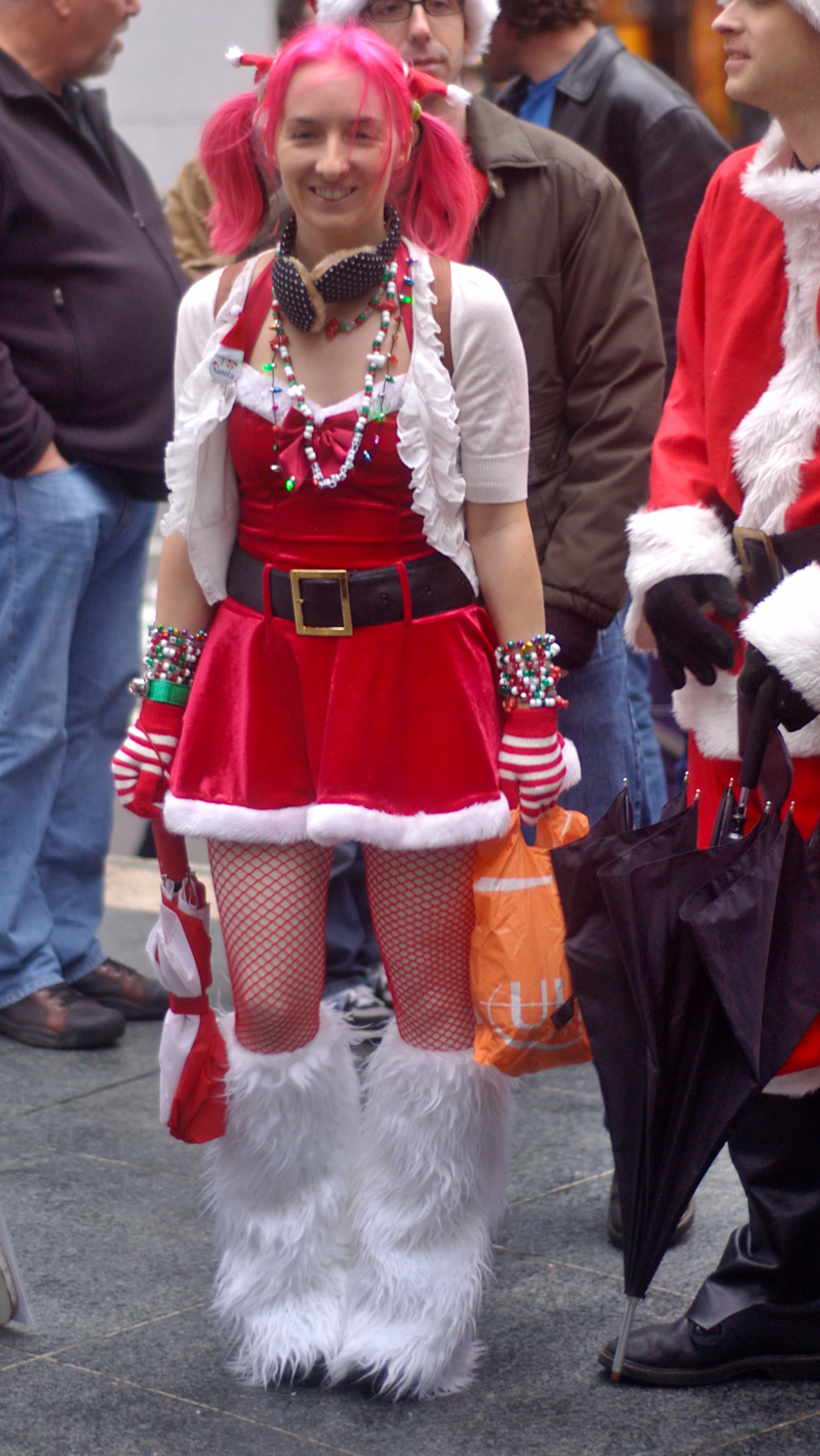 girl with pink hair and red clothes walking on the street