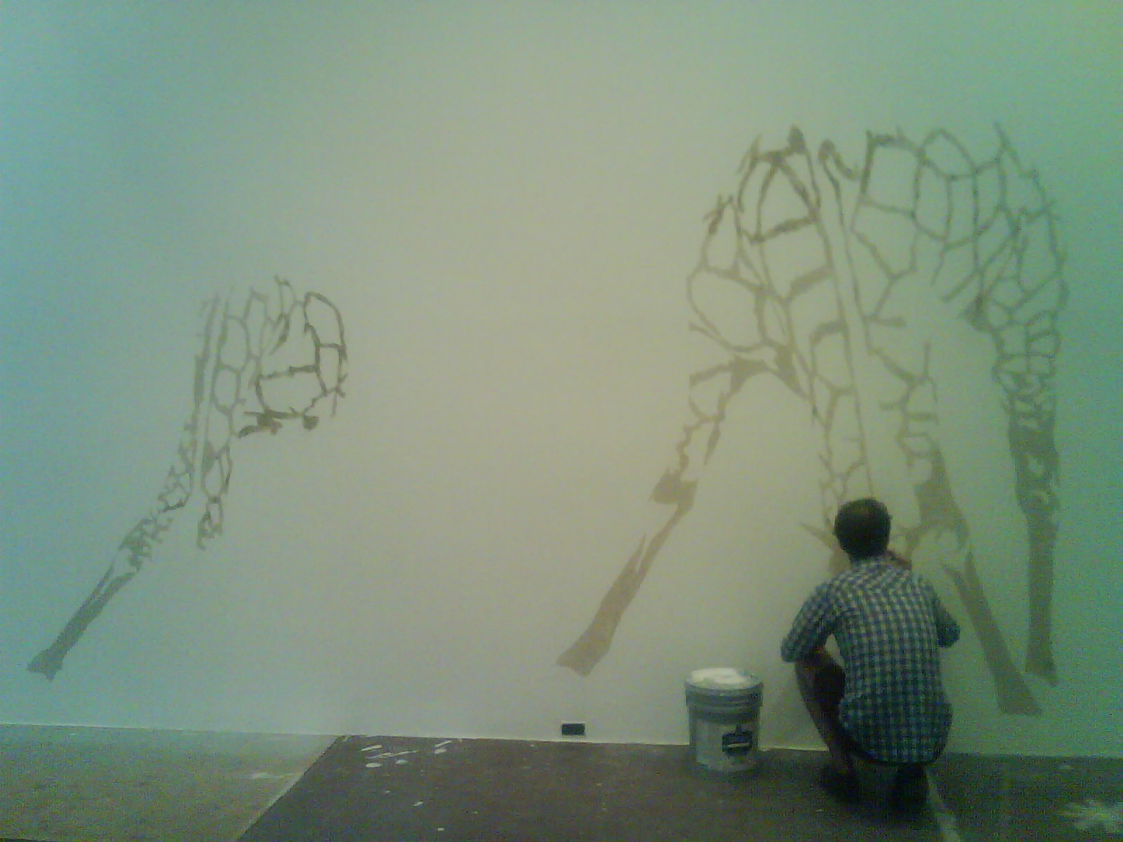 a man is painting some large objects on a wall