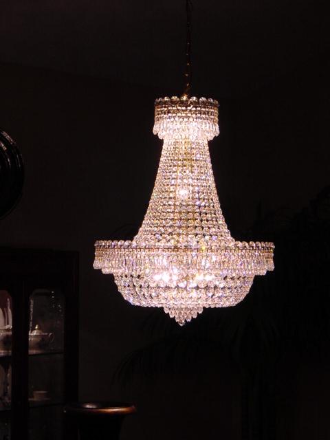 a crystal chandelier hangs from the ceiling in a dark room