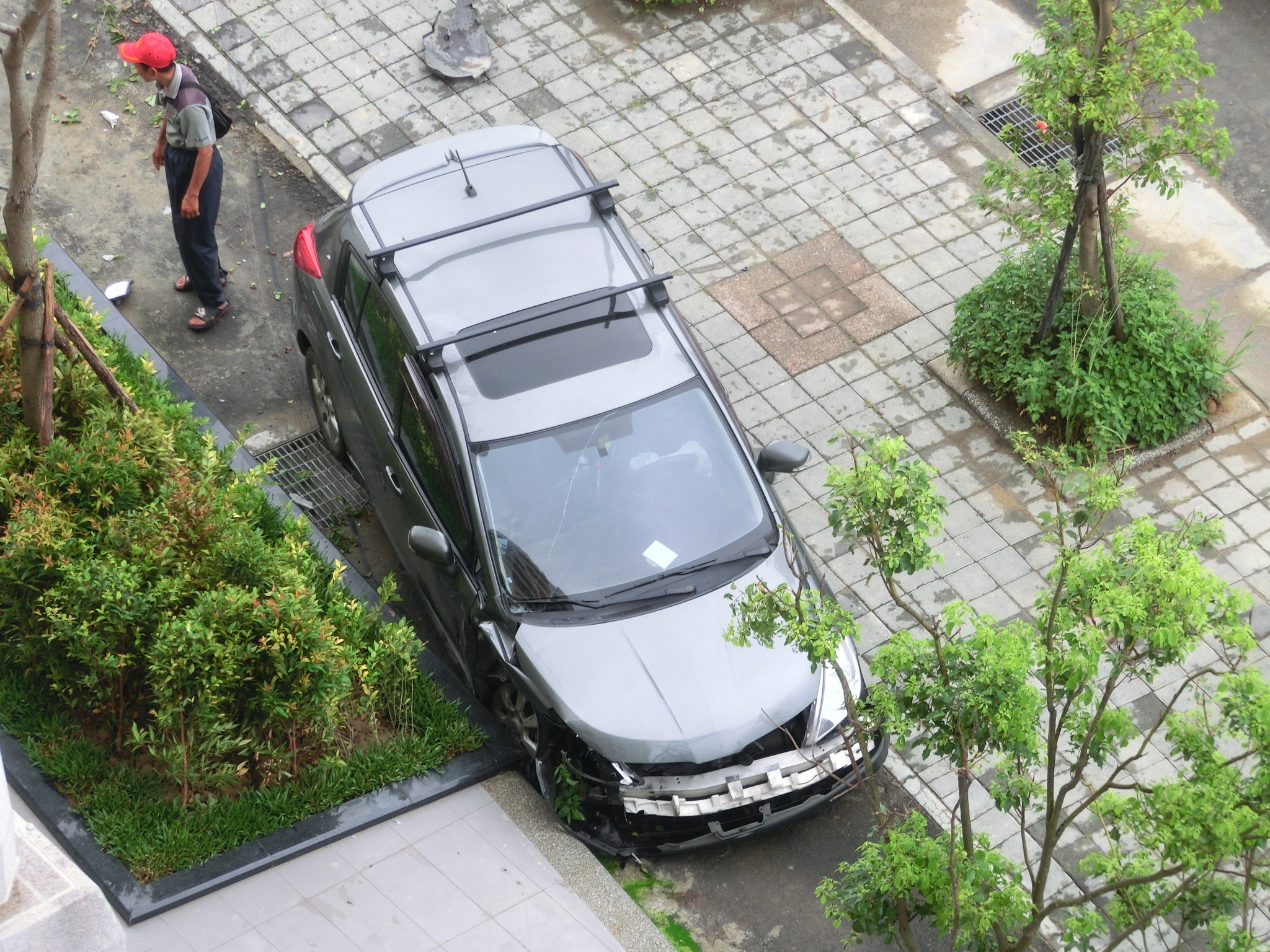 an aerial view of a street from above with several vehicles