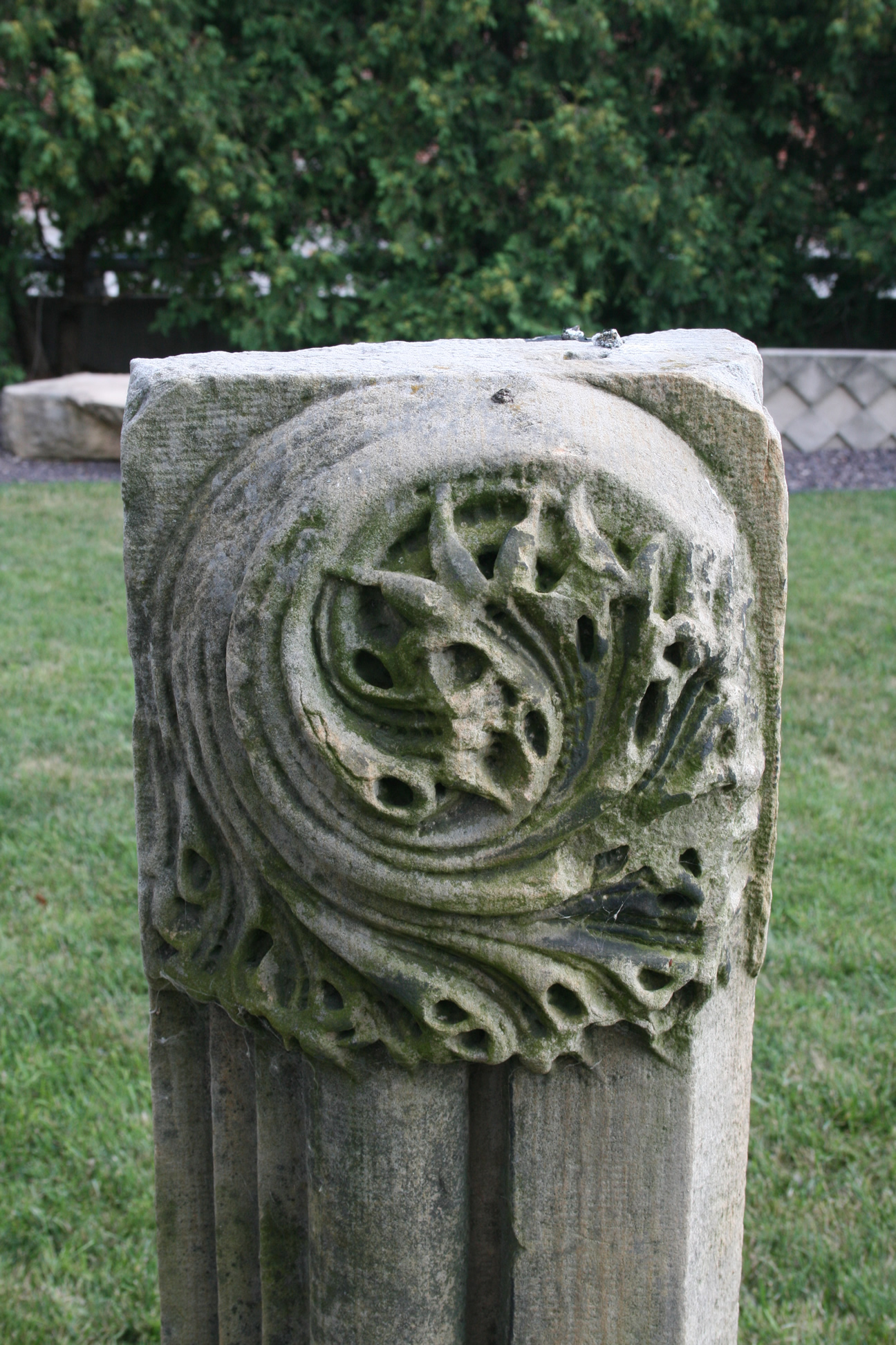 the old stone post has a circular knot around it