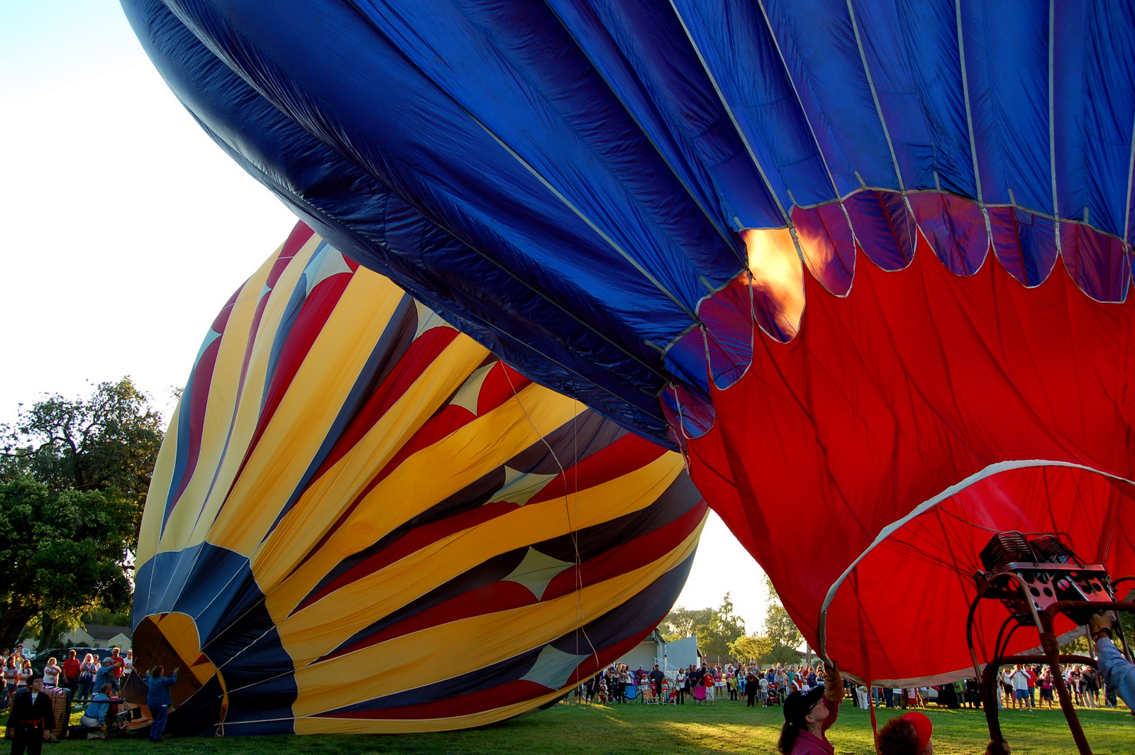 many large colorful  air balloons in a field