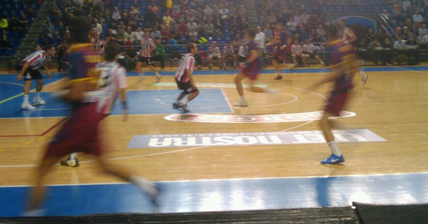 a blurred po of a basketball game from the sidelines