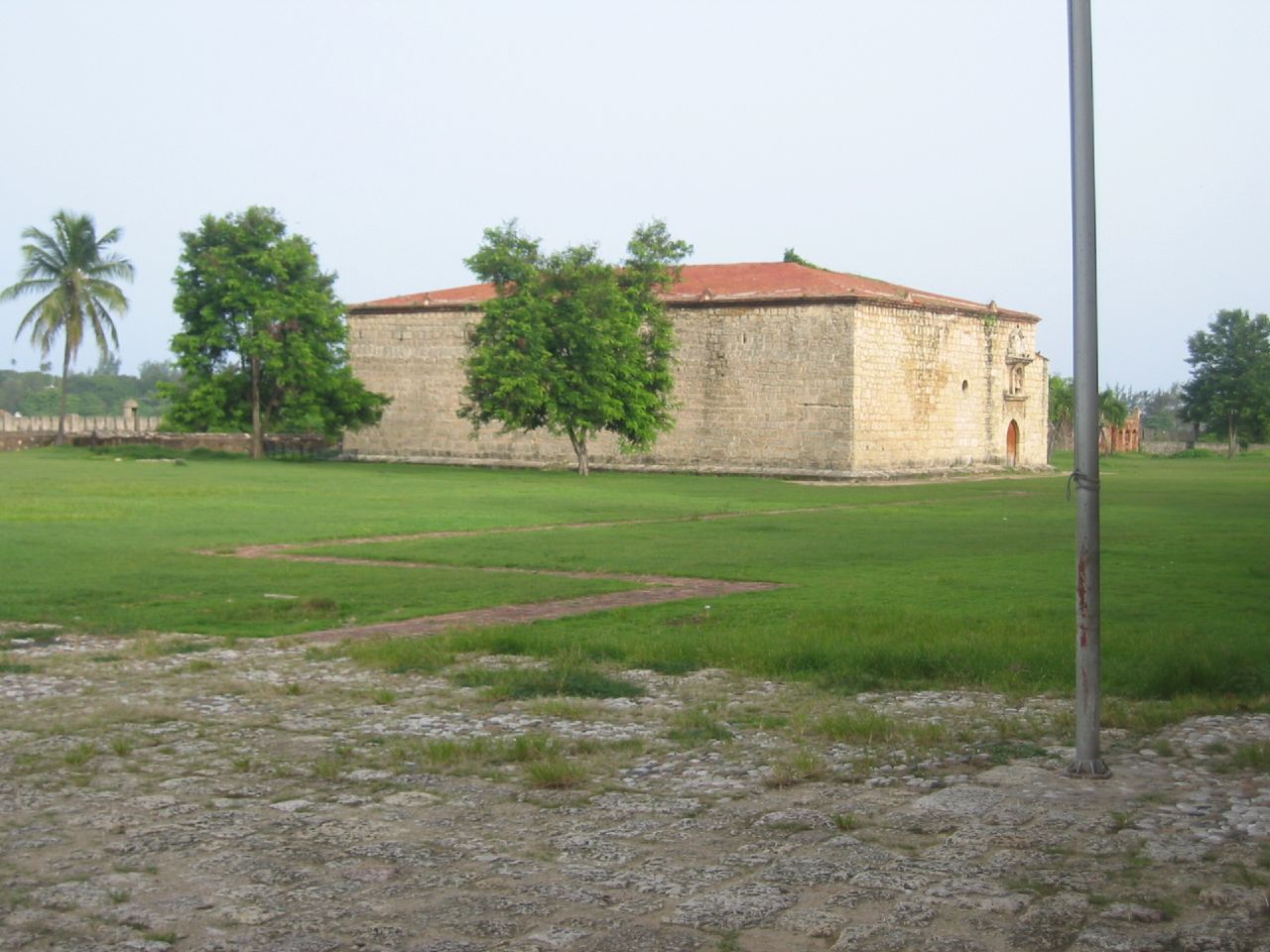 a field that has a large building in it