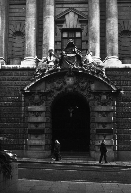 the man is walking into the entrance to the building