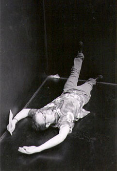 black and white image of young woman lying on floor