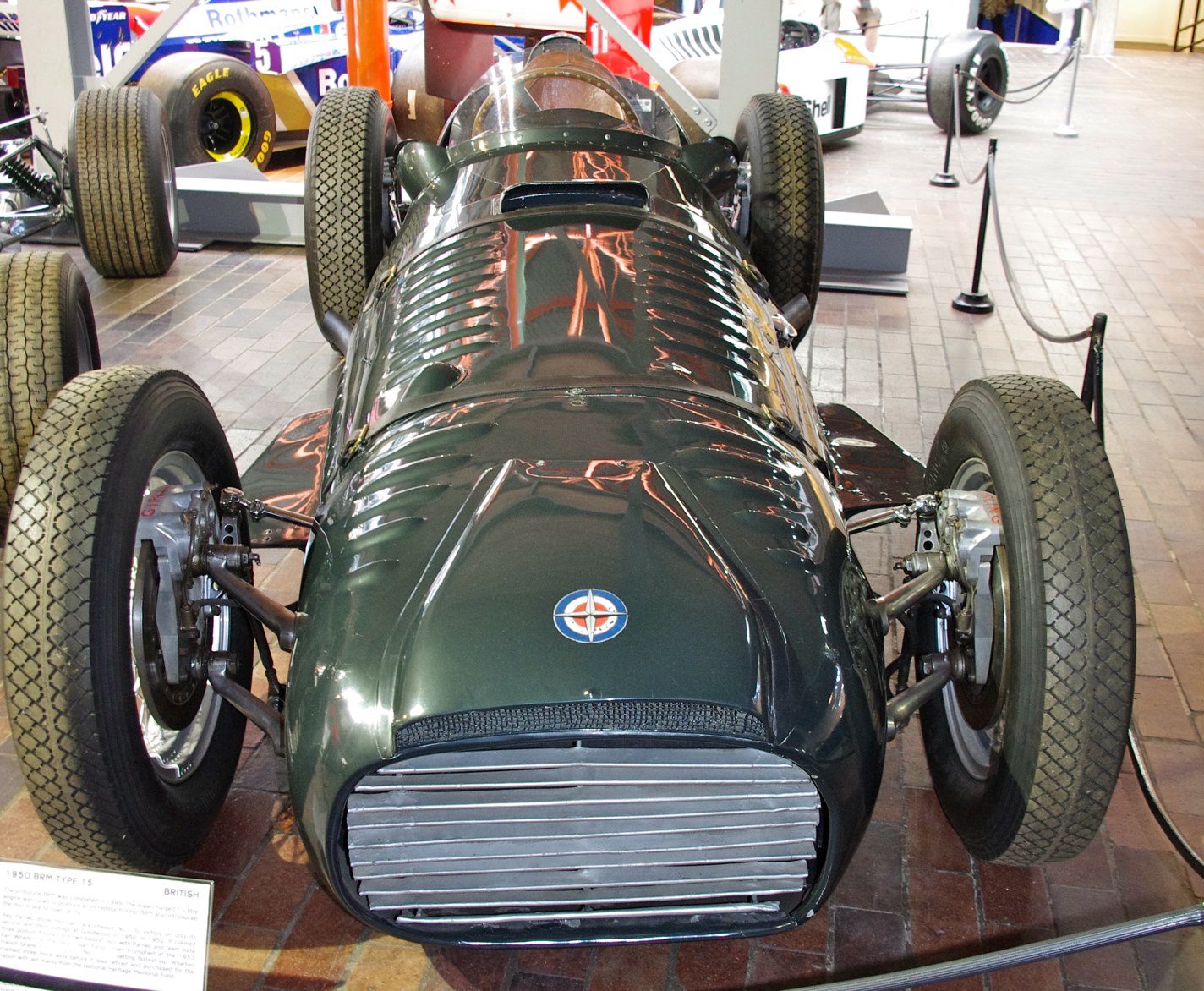 a vintage racing car being worked on on display