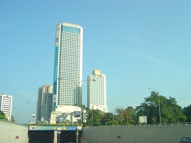 view from an intersection, of two tall buildings with modern skyscrs