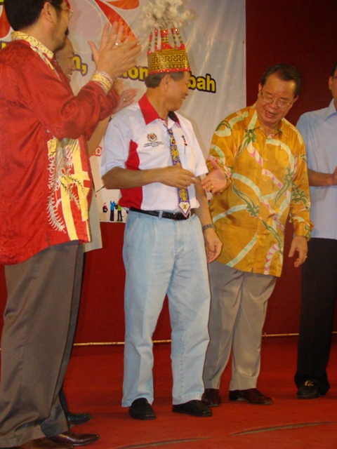 two men in colorful outfits talking to another man