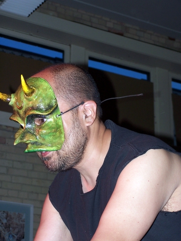 a man with his face painted green and devilish