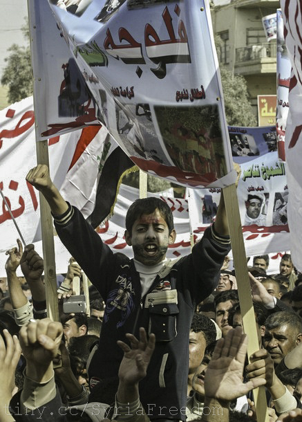 man waving flags in front of protesters