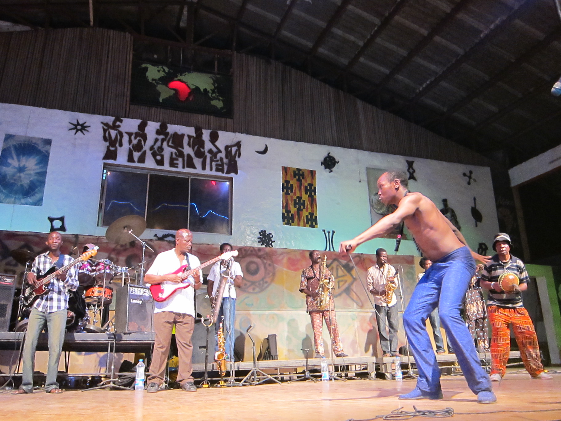 a group of men are performing on a stage