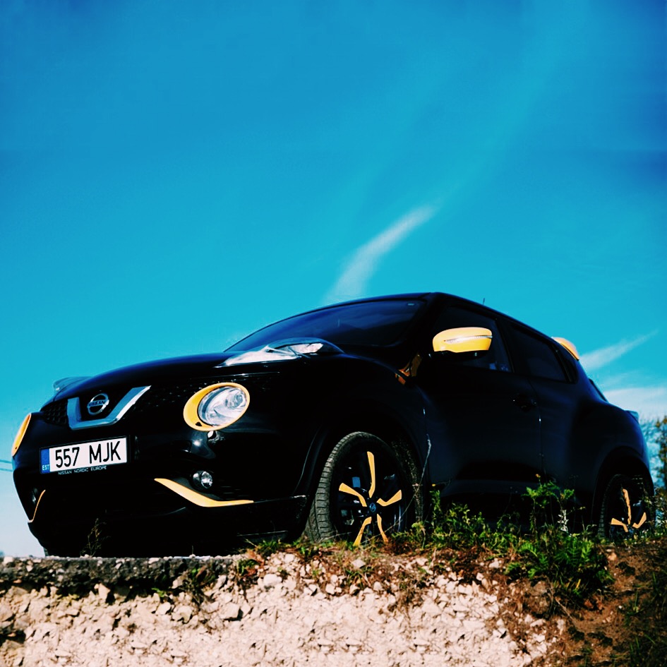 a black car is parked on a hill side