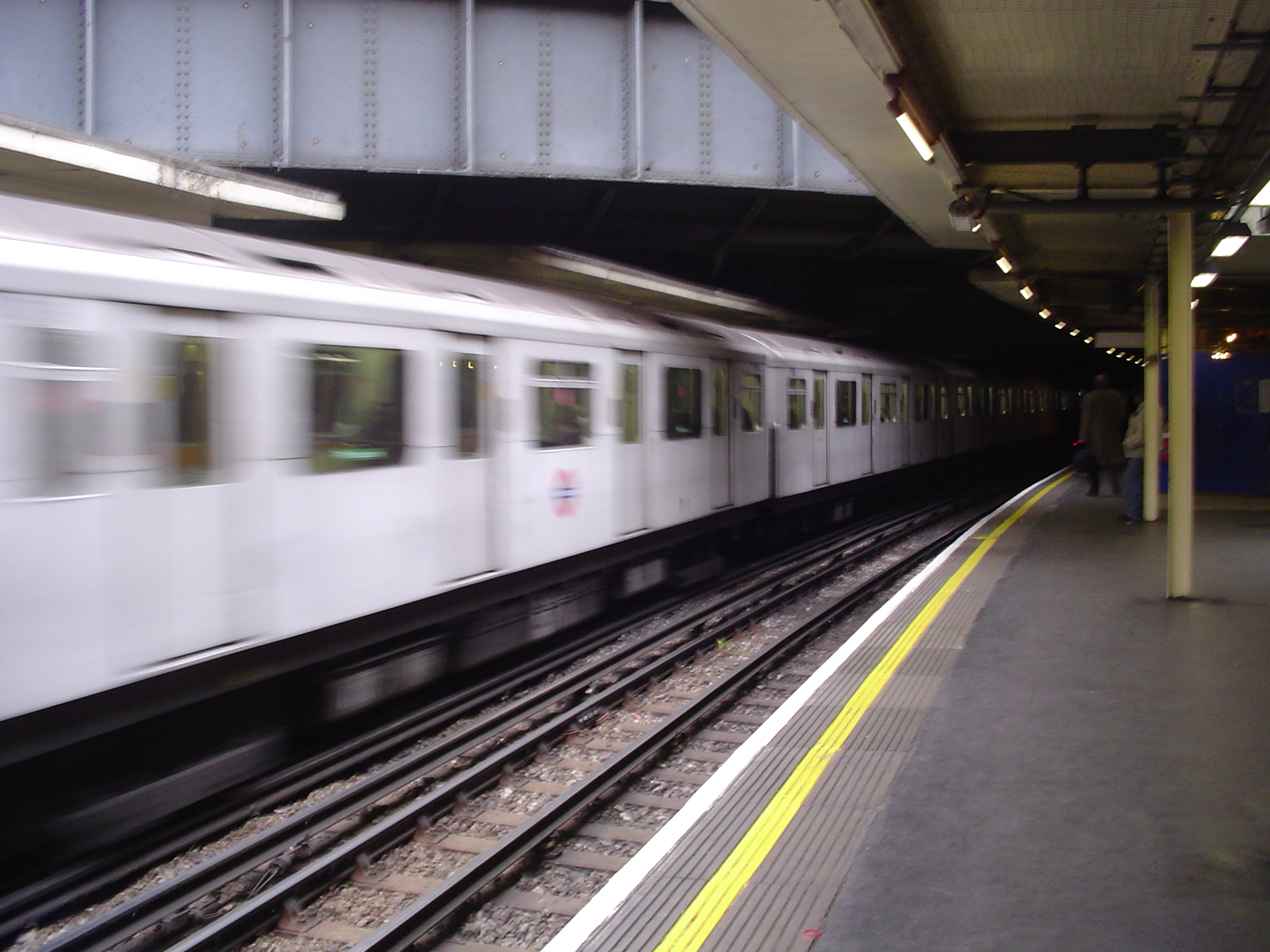 a train moves along an elevated platform in a station