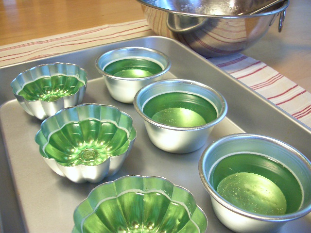 four bowls with liquid sit on the top of a pan