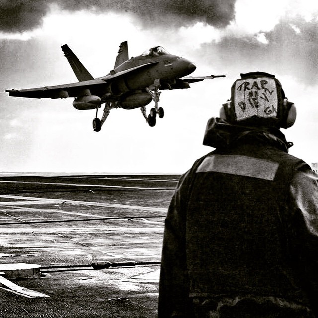 a fighter jet taking off from an aircraft carrier