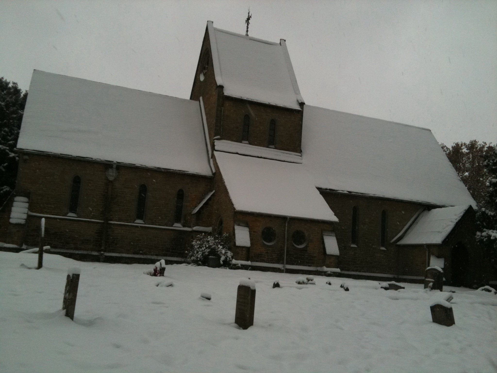 an old church covered in snow with tall spires