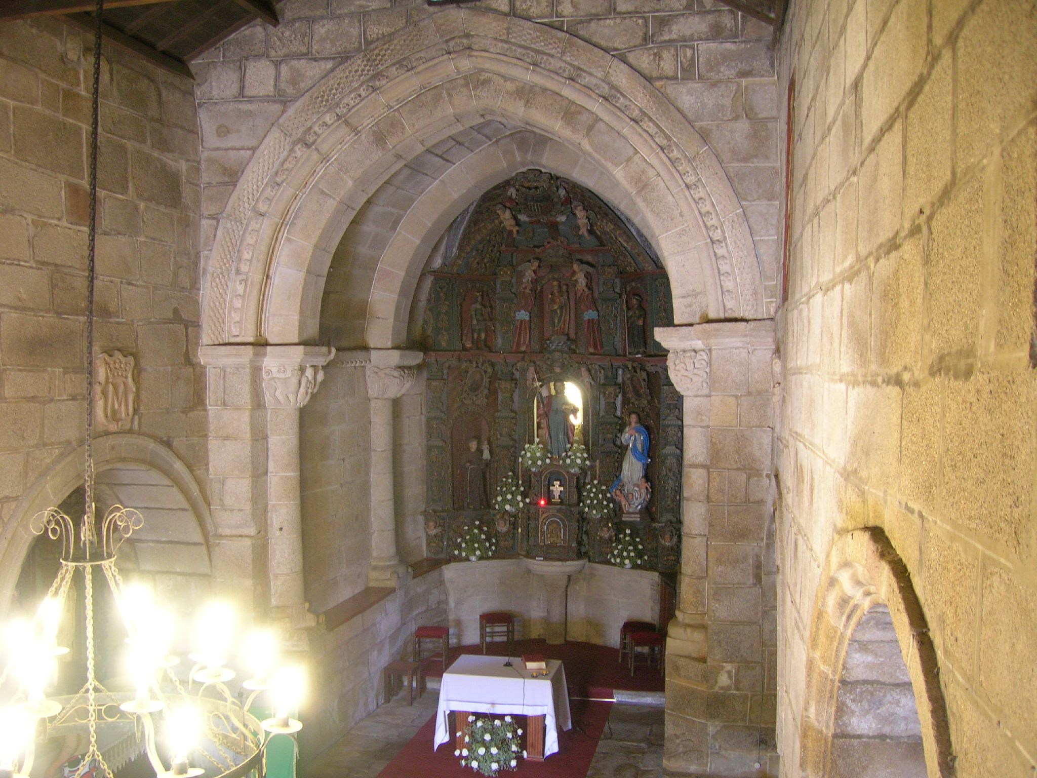an ancient church with stained glass windows and chandelier
