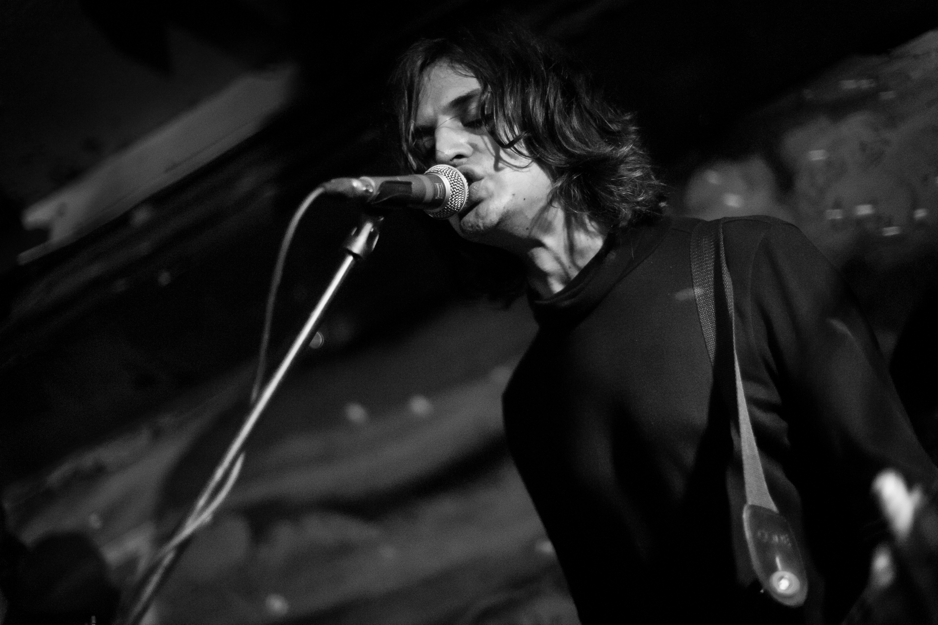 a young man singing into a microphone