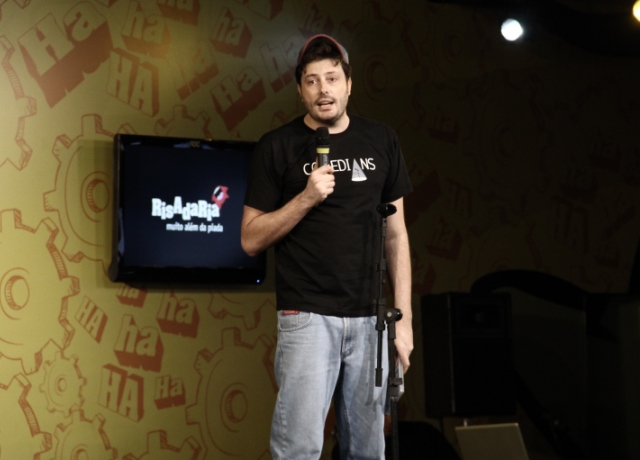 a man speaking at a convention while holding a microphone