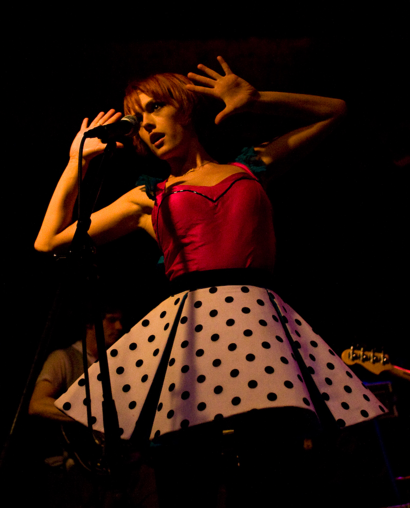 a woman in a dress standing on a stage