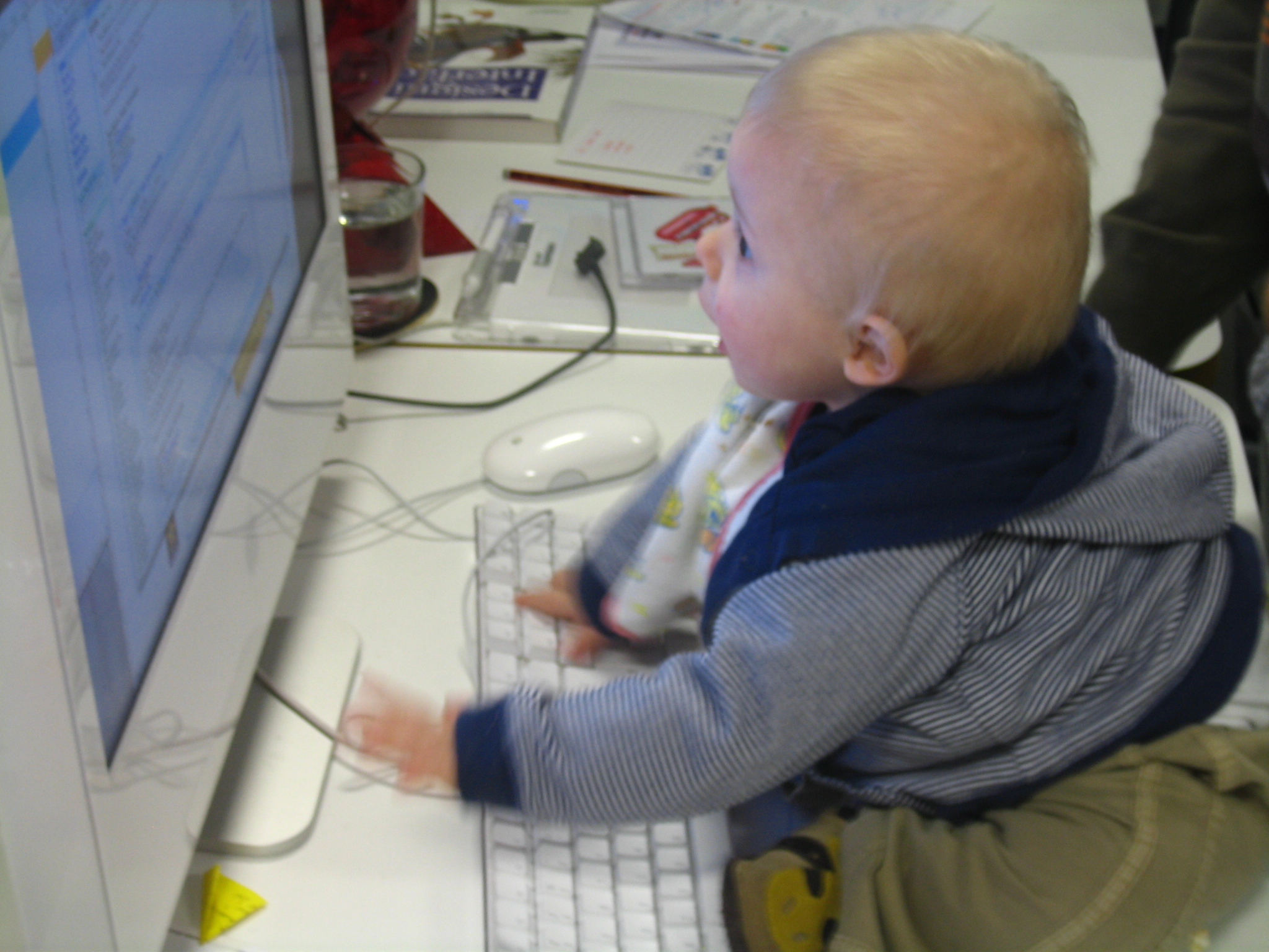 young child learning to use computer at desk