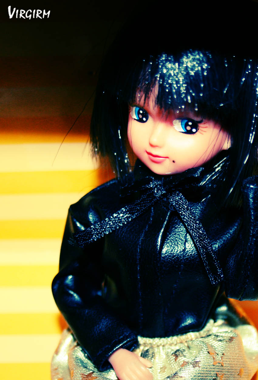 a very cute doll wearing a black jacket and dress