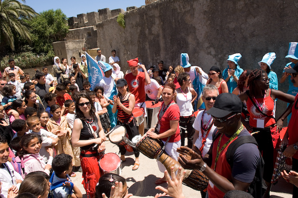 a group of people are gathered in front of a building