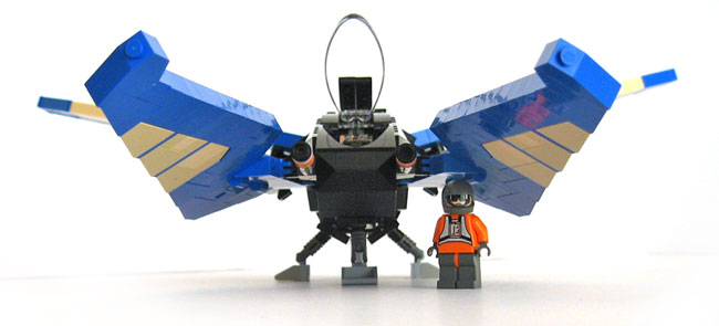 a lego model is standing next to a small robot