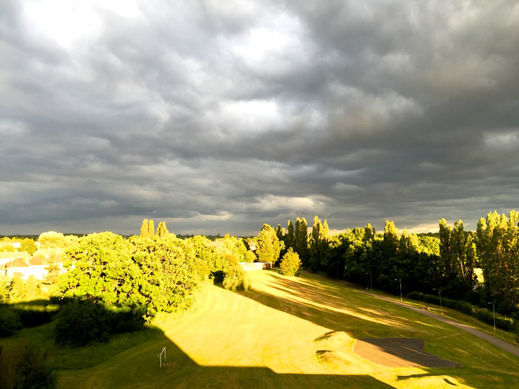 the cloudy view from a hill looking down on the golf course