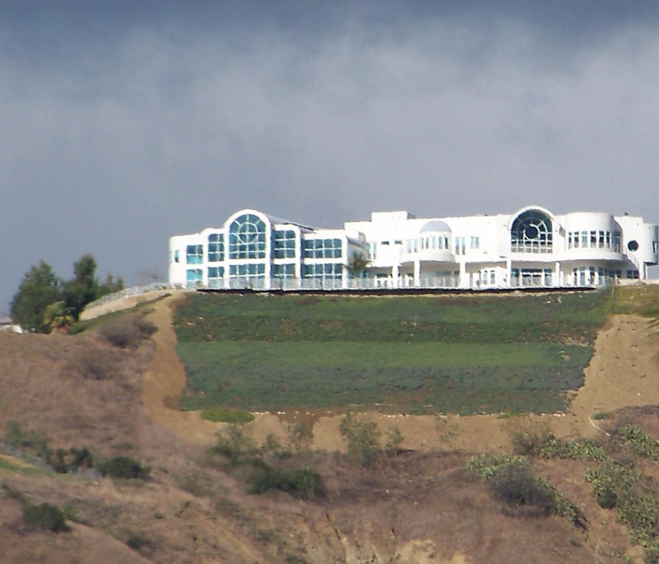 an elegant estate in a hilly area with green trees