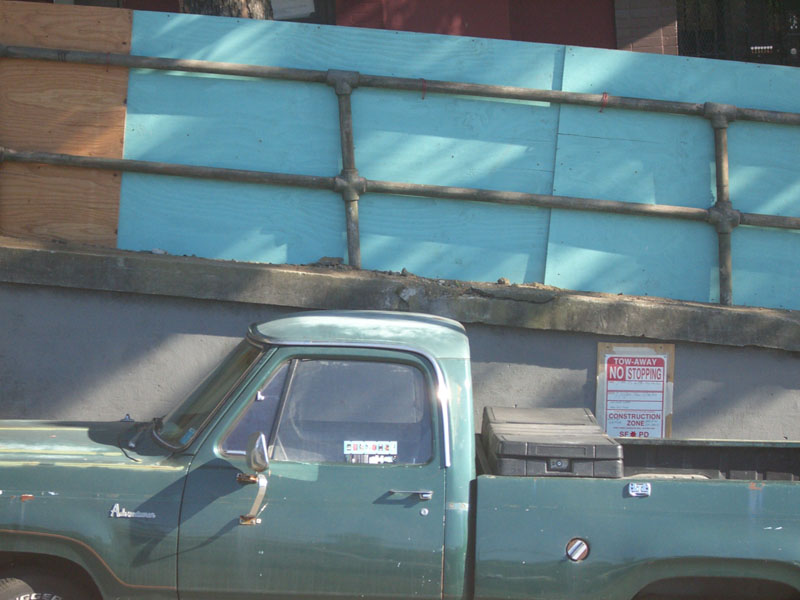 an old truck is parked in front of a building