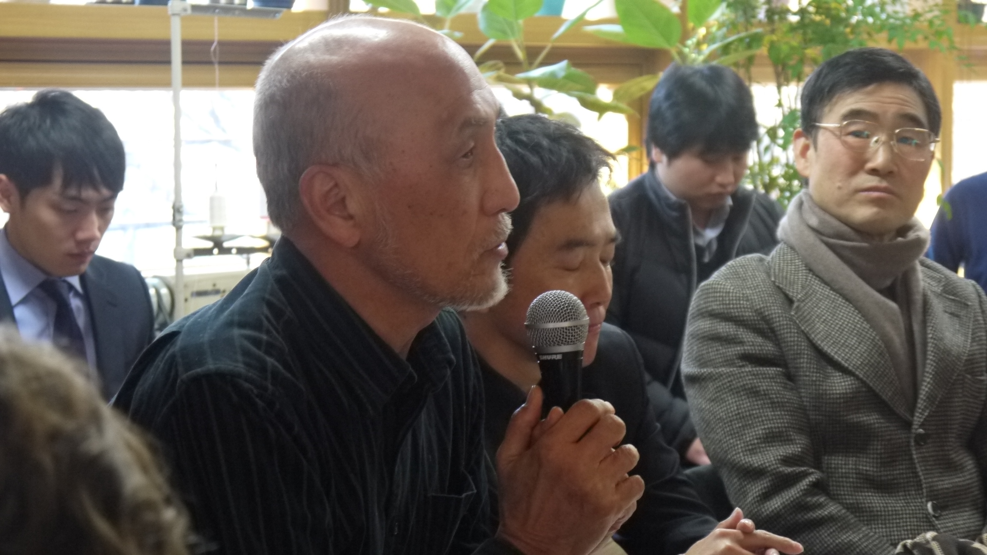 a man speaking in front of a group of people