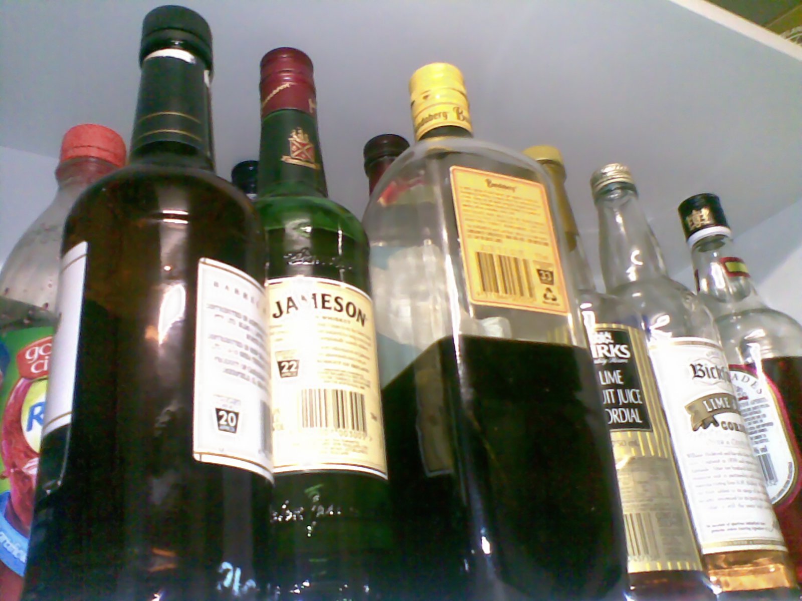 a close up of bottles of alcohol on a shelf