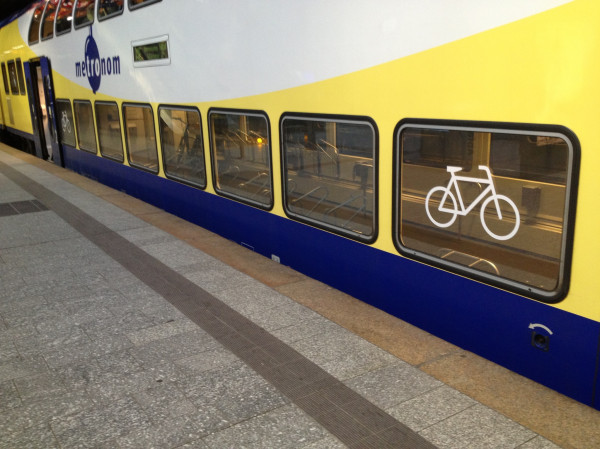 a train with windows that have a bicycle written on the side