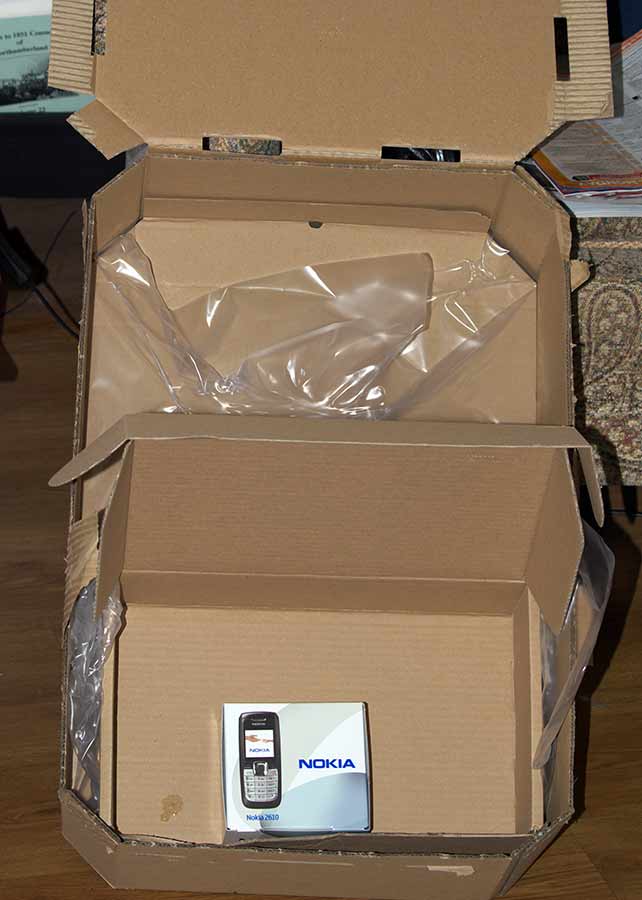 a cardboard box with a cellphone in it