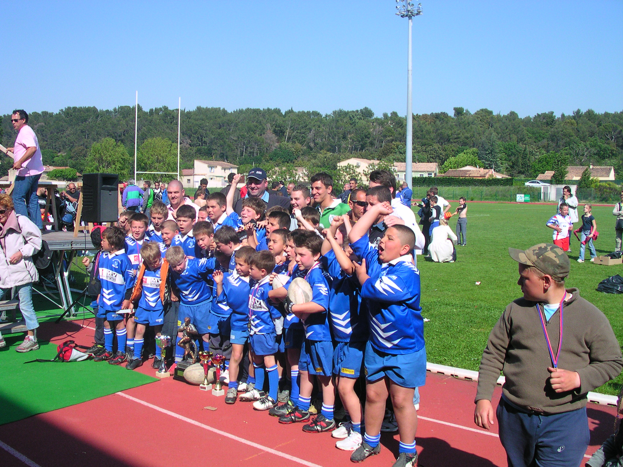 group of children at soccer game having trophy show