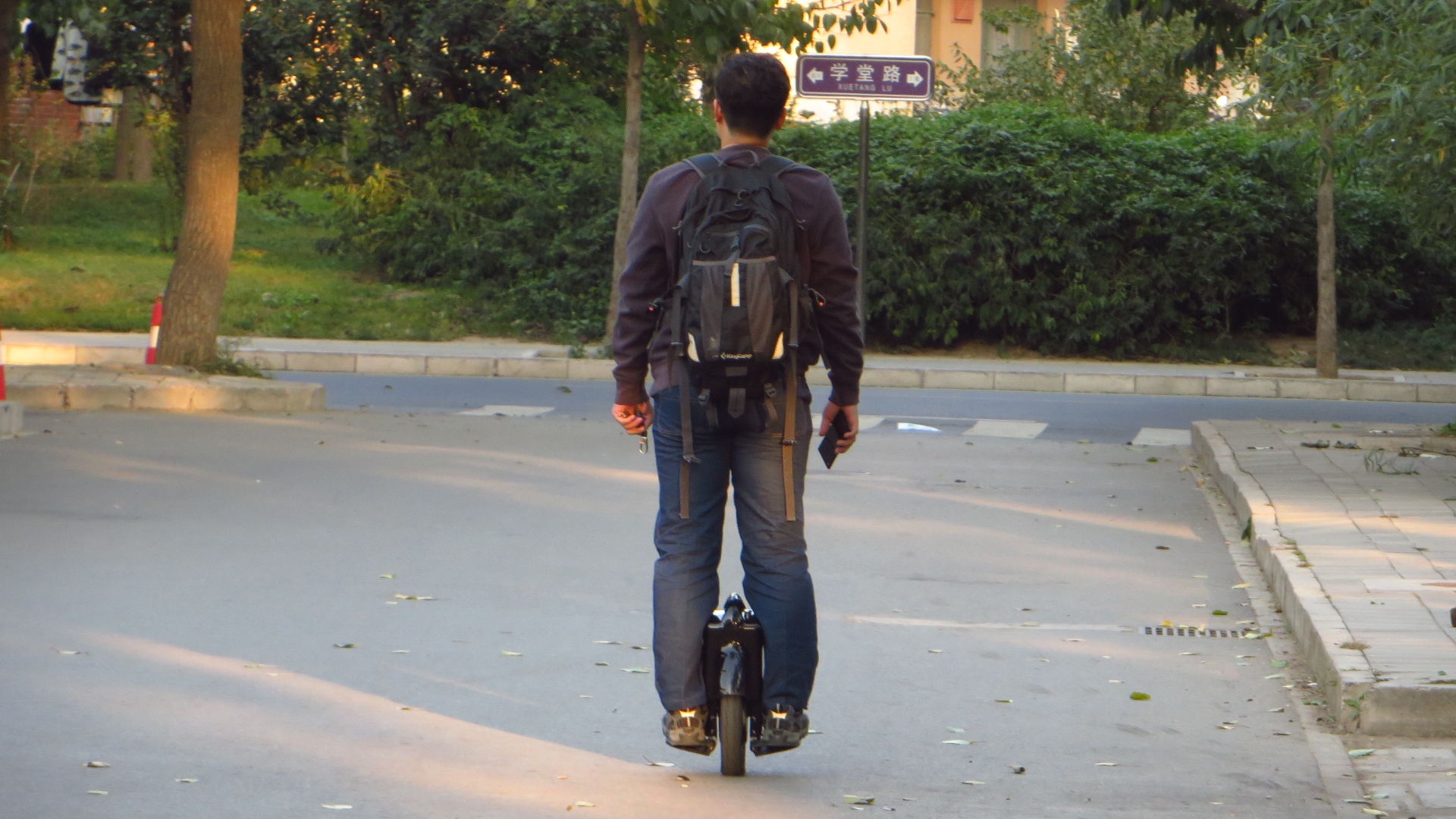 a man riding a skate board down a street