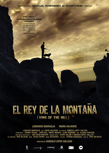 a poster with a man and a dog on top of a mountain