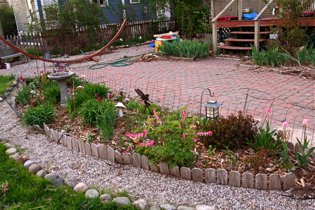 a yard filled with plants and stones
