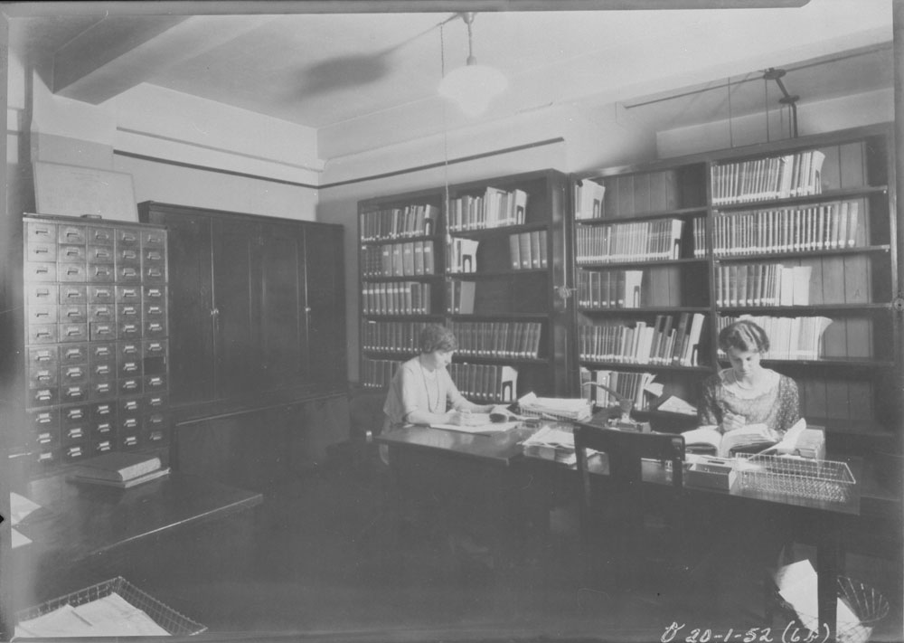 two women are sitting at the table in the liry