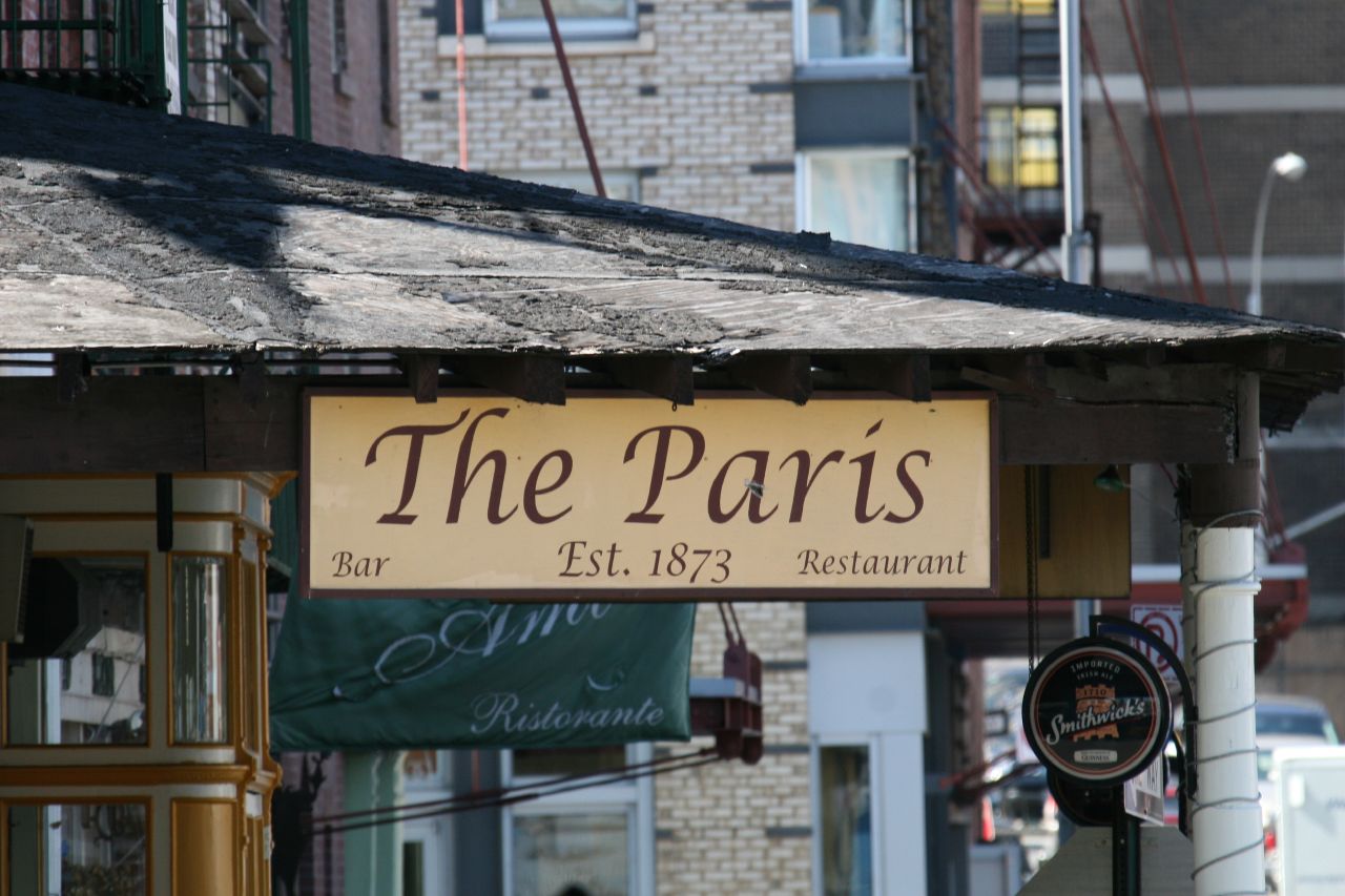a small store has a sign for the paris restaurant