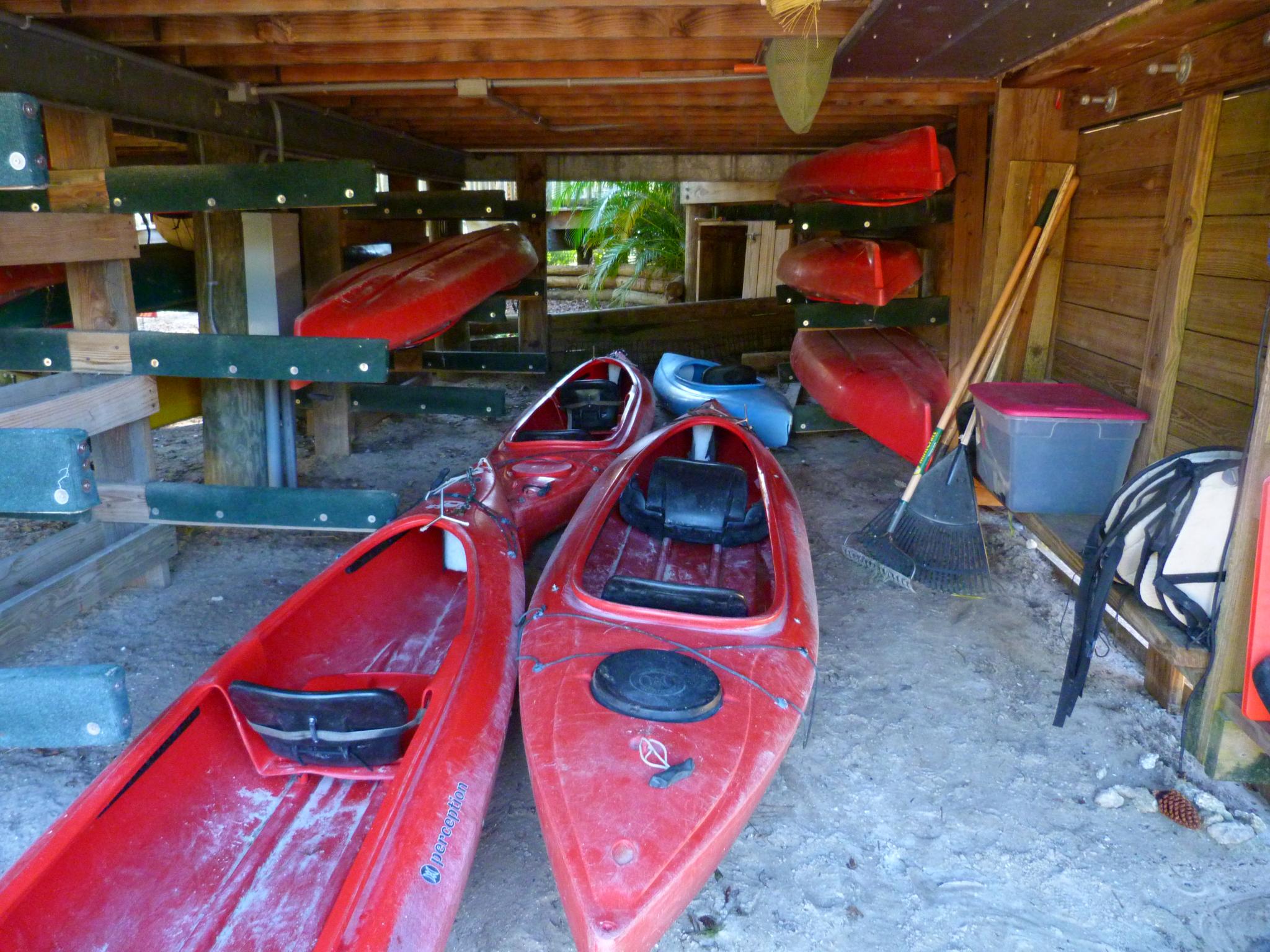 a beach covered with many kayaks in the sand